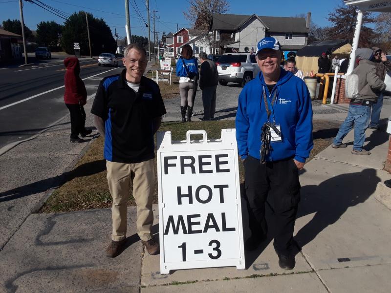 Volunteer Nick Levelle, left, and The Shepherd’s Office Director Jim Martin stand ready to welcome guests for free hot meals on Thanksgiving Day.